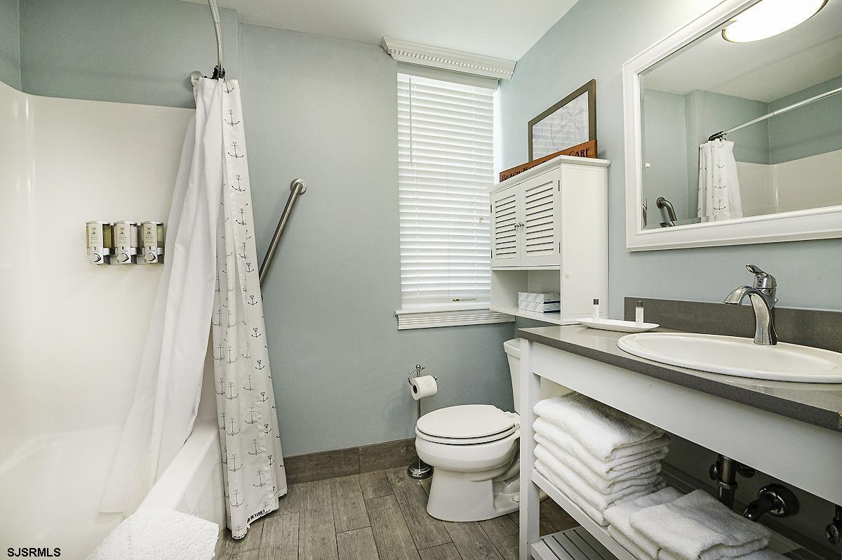 719 East 11th Street, Unit 915 Ocean City, NJ 08226 - Photo 16 of 27 a bathroom with a sink a toilet and shower