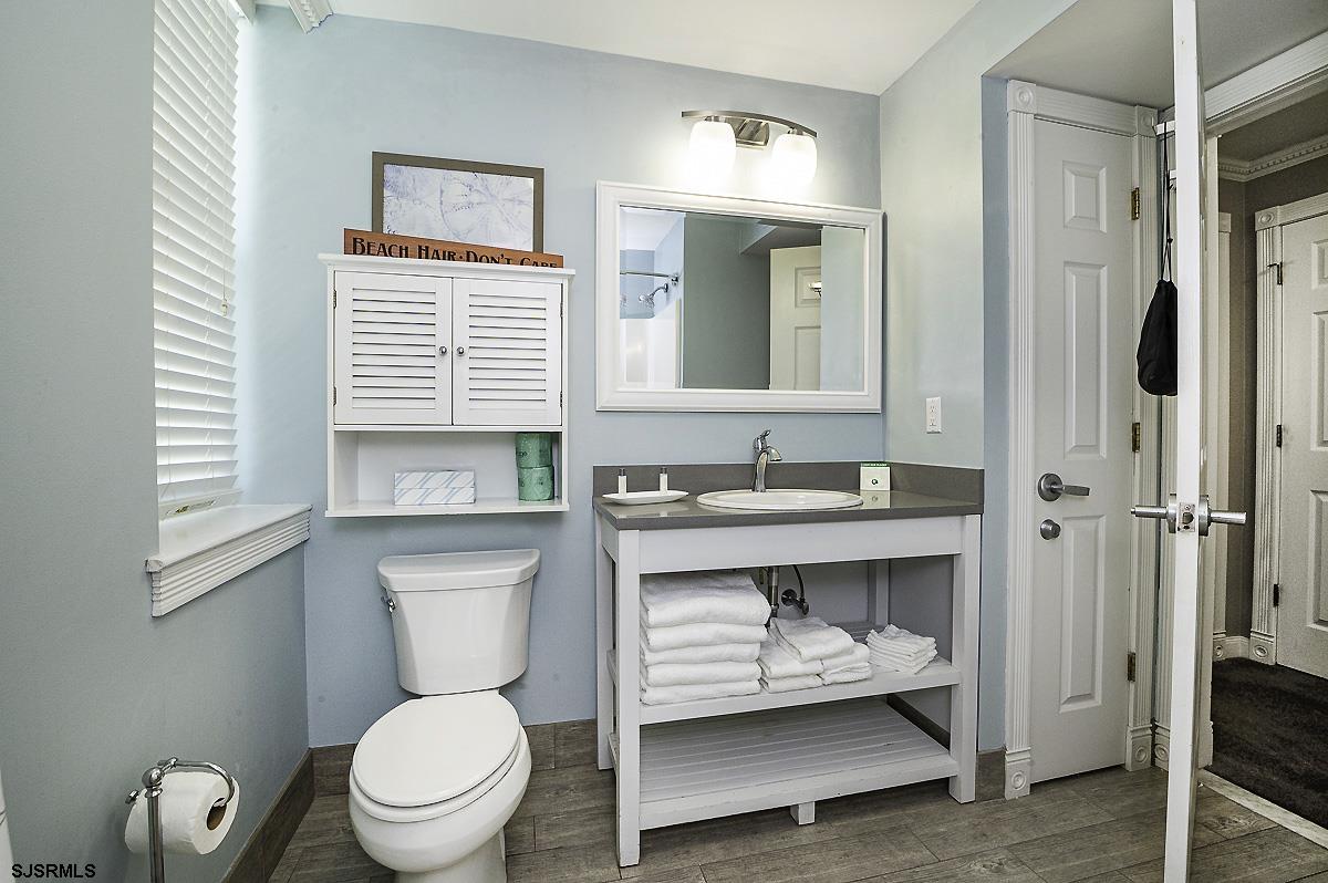 719 East 11th Street, Unit 915 Ocean City, NJ 08226 - Photo 18 of 27 a bathroom with a sink a toilet and shower