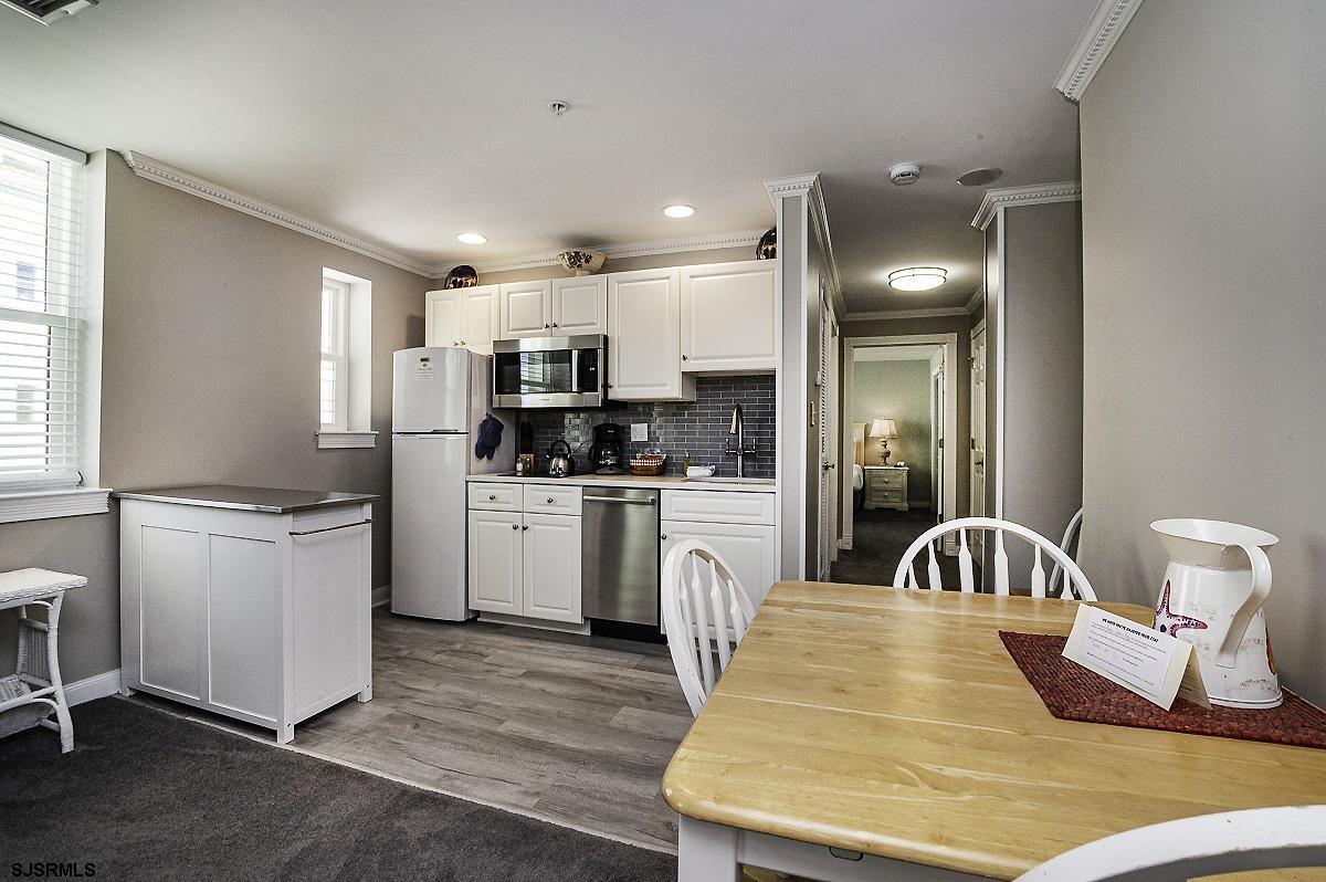 719 East 11th Street, Unit 915 Ocean City, NJ 08226 - Photo 4 of 27 a kitchen with a sink appliances cabinets and a window