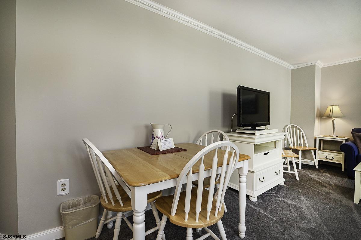 719 East 11th Street, Unit 915 Ocean City, NJ 08226 - Photo 5 of 27 a view of a dining room with furniture