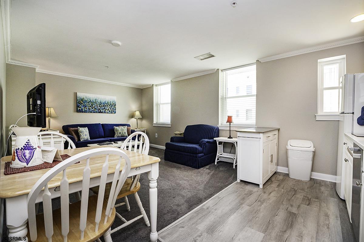 719 East 11th Street, Unit 915 Ocean City, NJ 08226 - Photo 6 of 27 a living room with furniture a flat screen tv and a window