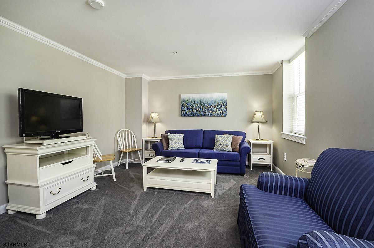 719 East 11th Street, Unit 915 Ocean City, NJ 08226 - Photo 7 of 27 a living room with furniture and a flat screen tv