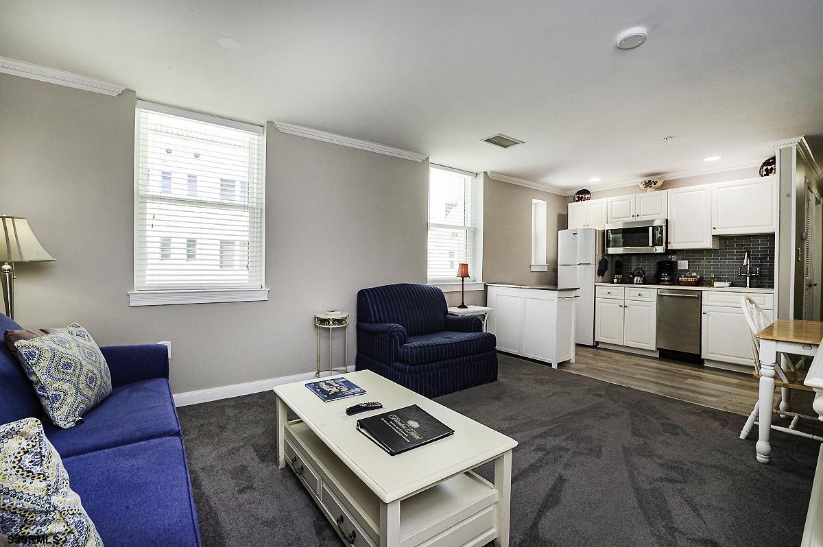 719 East 11th Street, Unit 915 Ocean City, NJ 08226 - Photo 10 of 27 a living room with furniture and kitchen view