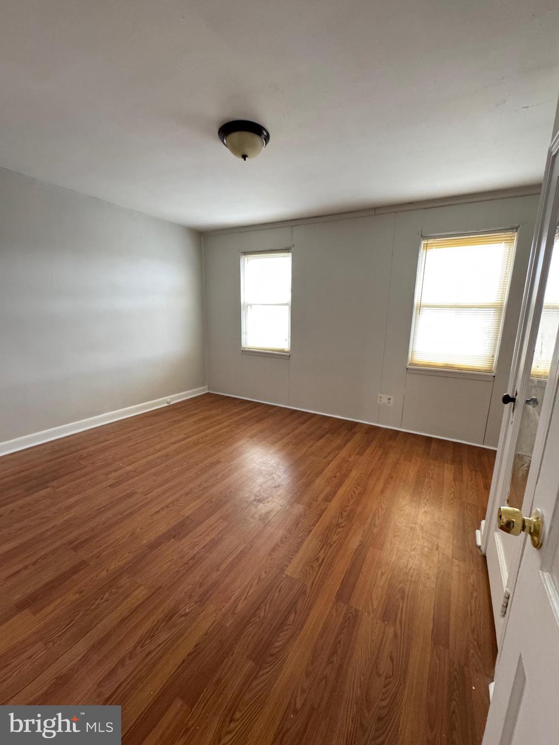 3255 Friendship Street Philadelphia, PA 19149 - Photo 2 of 11 an empty room with wooden floor and windows