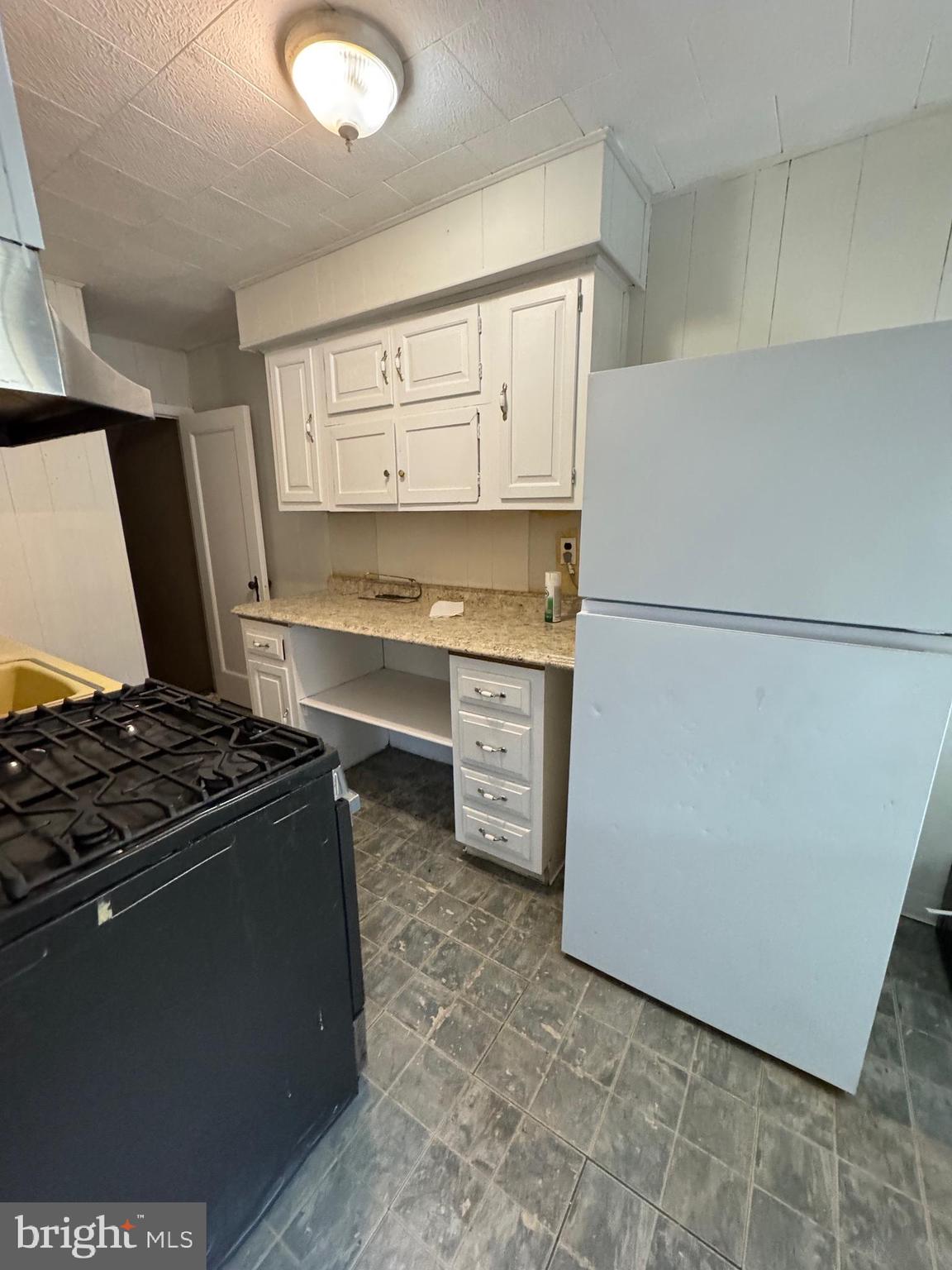 3255 Friendship Street Philadelphia, PA 19149 - Photo 6 of 11 a kitchen with a stove and a refrigerator