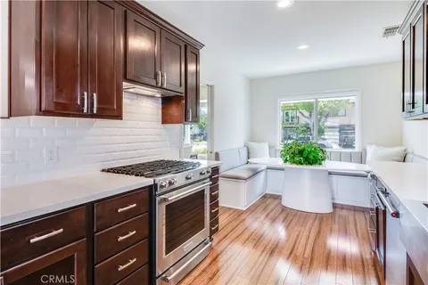 a kitchen with granite countertop wooden floors and sink
