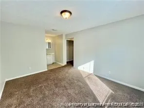 a view of a big room with closet and windows