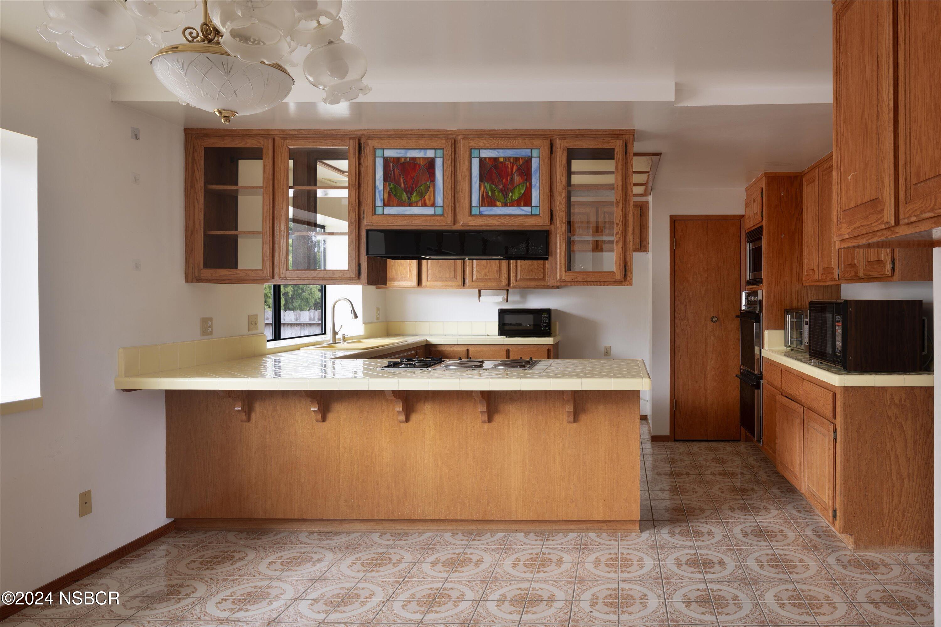 970 Onstott Road Lompoc, CA 93436 - Photo 13 of 38 a kitchen with stainless steel appliances granite countertop a sink stove and refrigerator