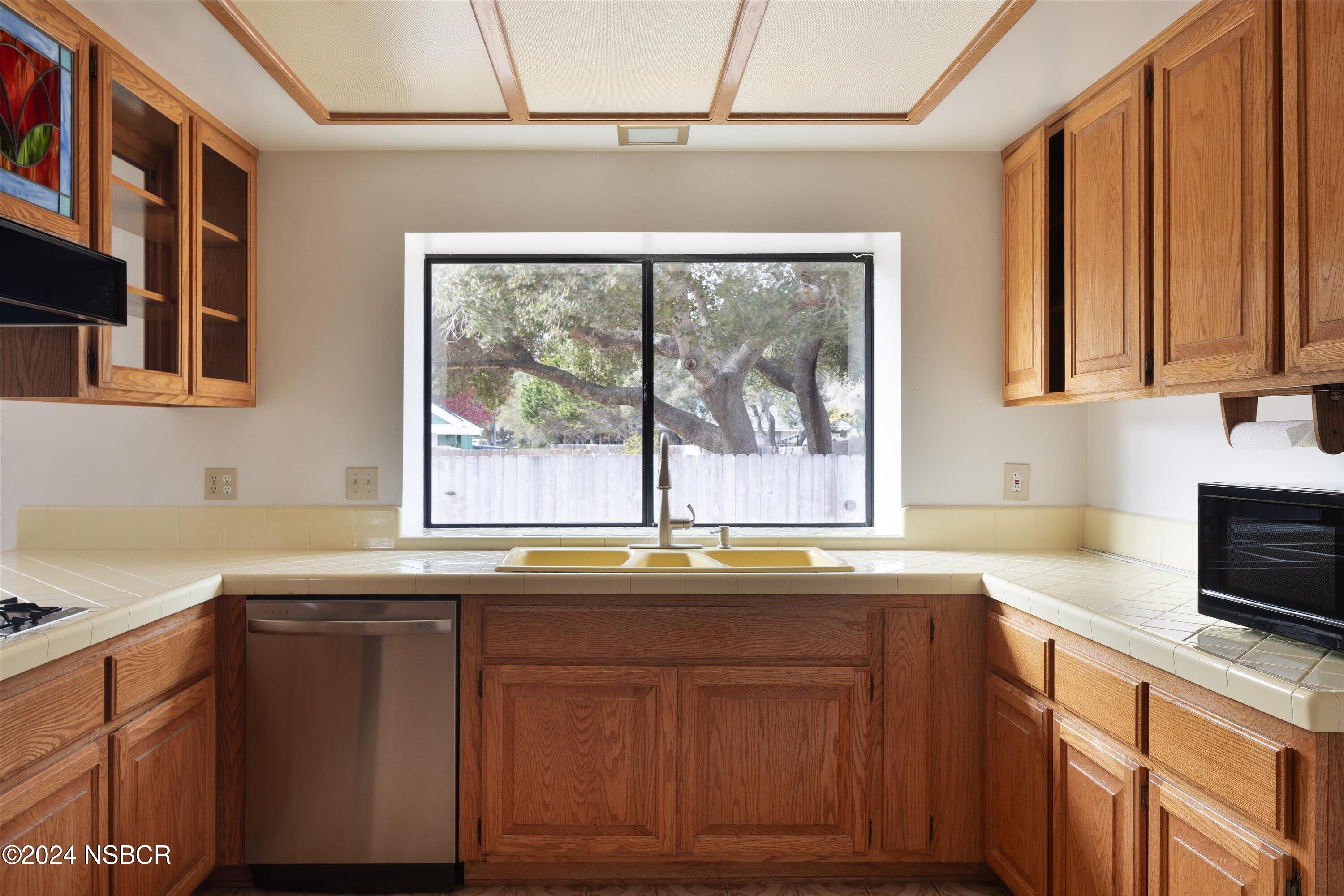 970 Onstott Road Lompoc, CA 93436 - Photo 15 of 38 a kitchen with granite countertop a sink and a window