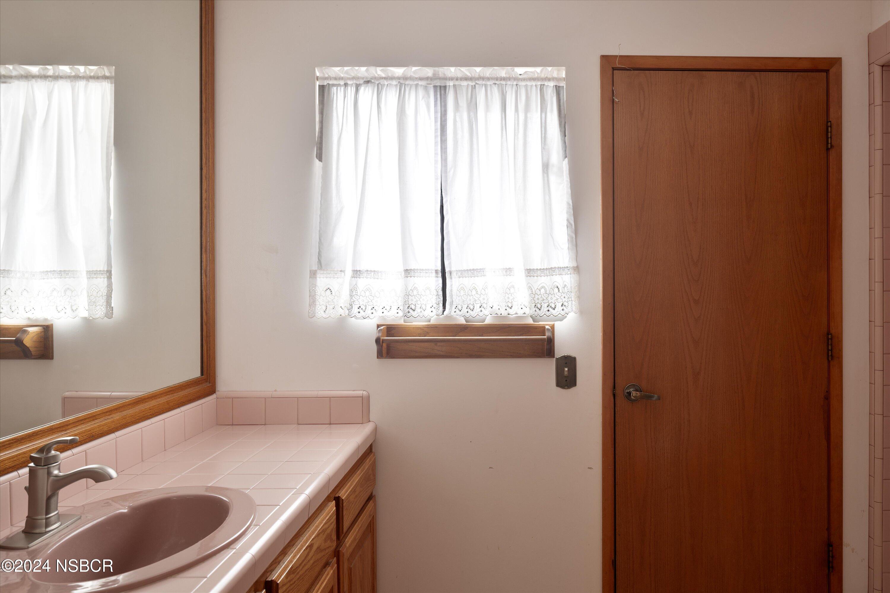 970 Onstott Road Lompoc, CA 93436 - Photo 23 of 38 a bathroom with a sink a toilet and a window