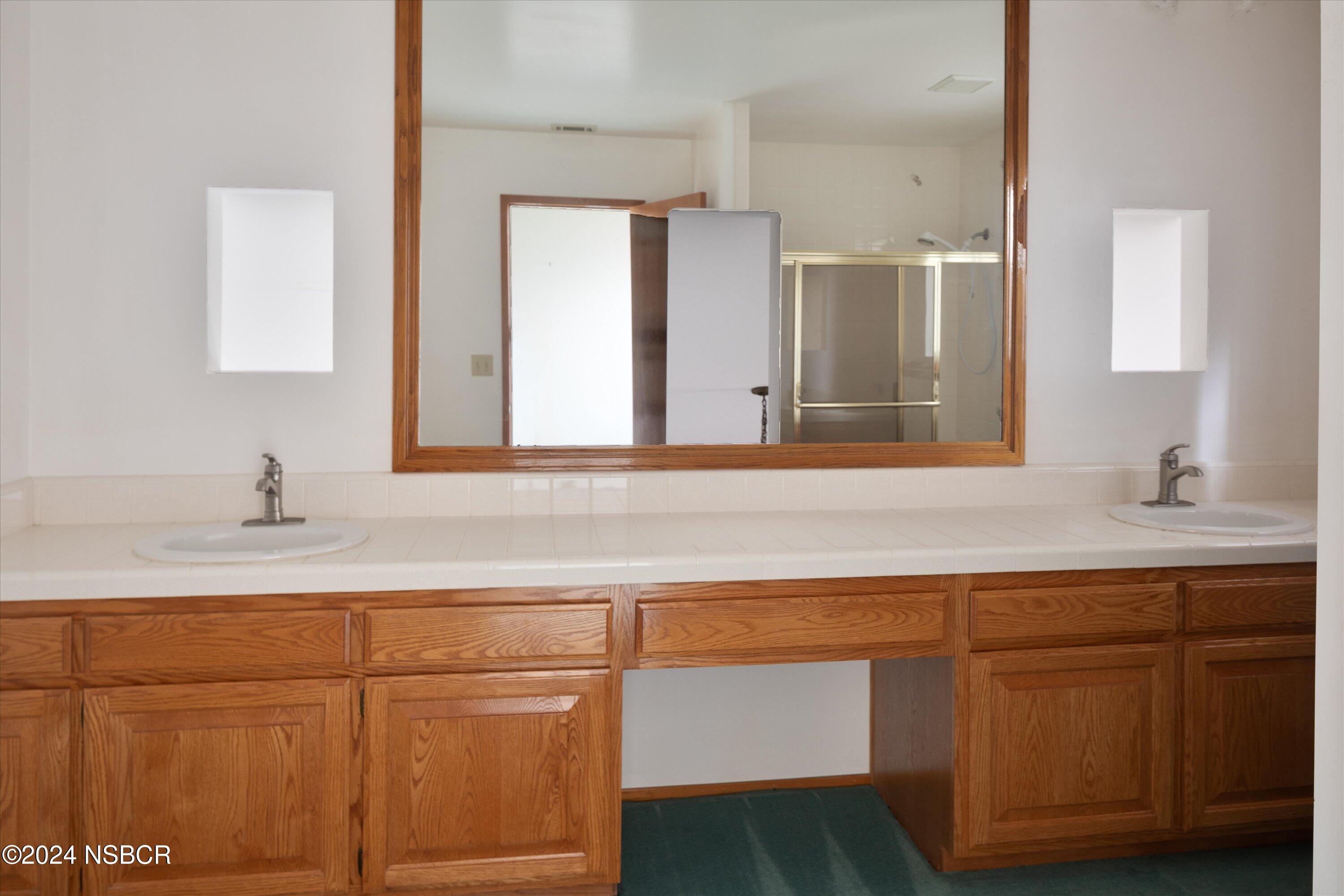 970 Onstott Road Lompoc, CA 93436 - Photo 25 of 38 a bathroom with a sink and a mirror