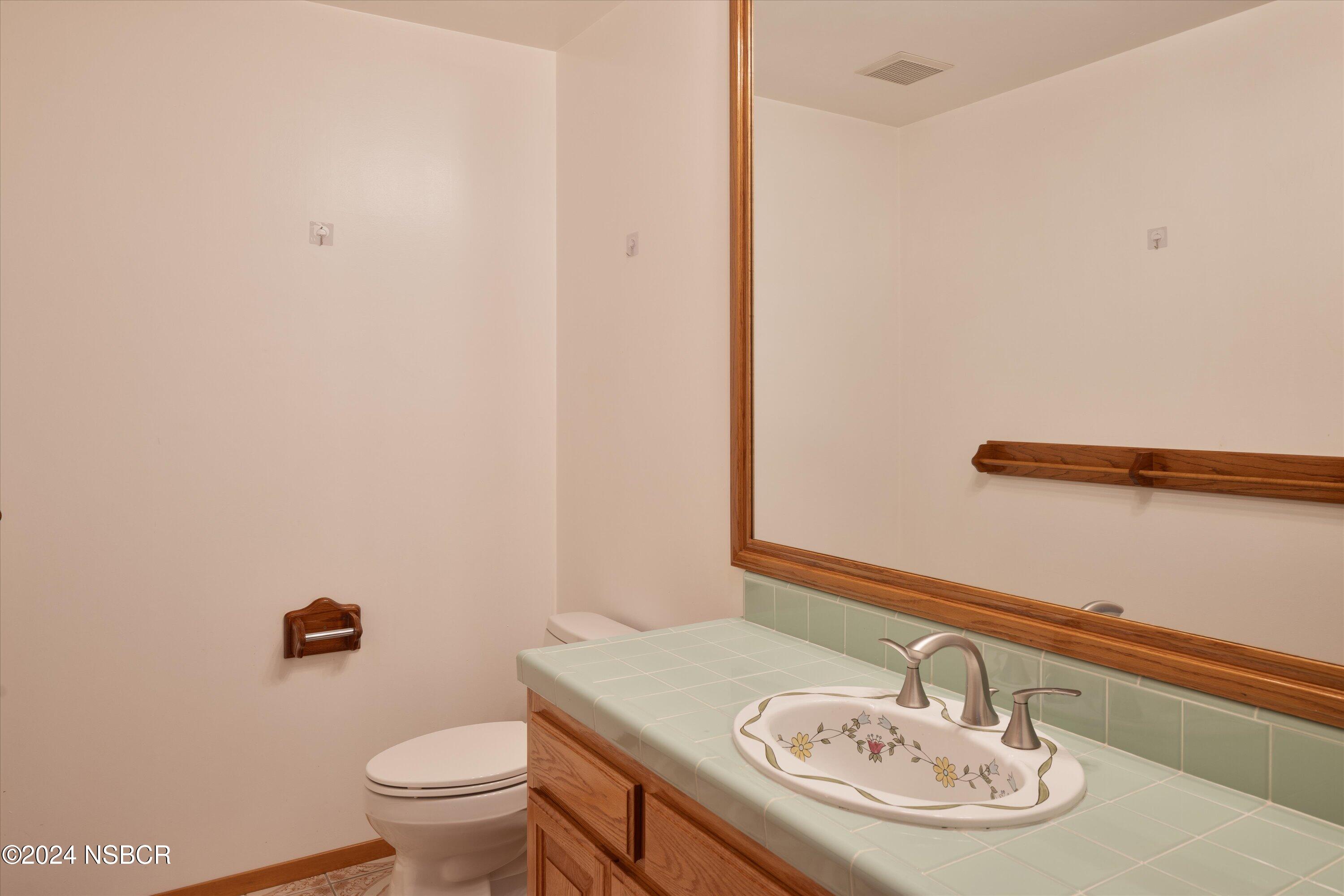 970 Onstott Road Lompoc, CA 93436 - Photo 30 of 38 a bathroom with a sink a toilet and mirror