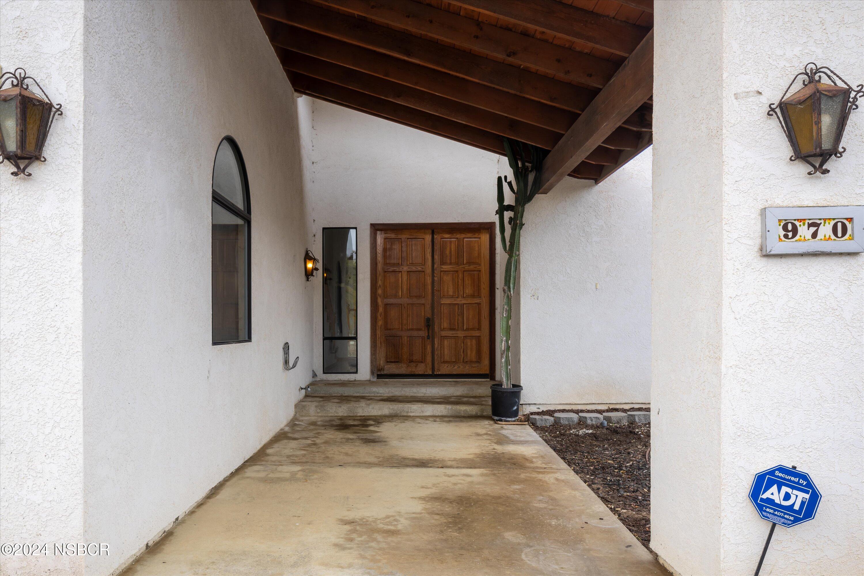970 Onstott Road Lompoc, CA 93436 - Photo 5 of 38 a view of a hallway with wooden walls and windows