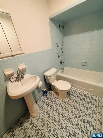 a bathroom with a sink a toilet and mirror
