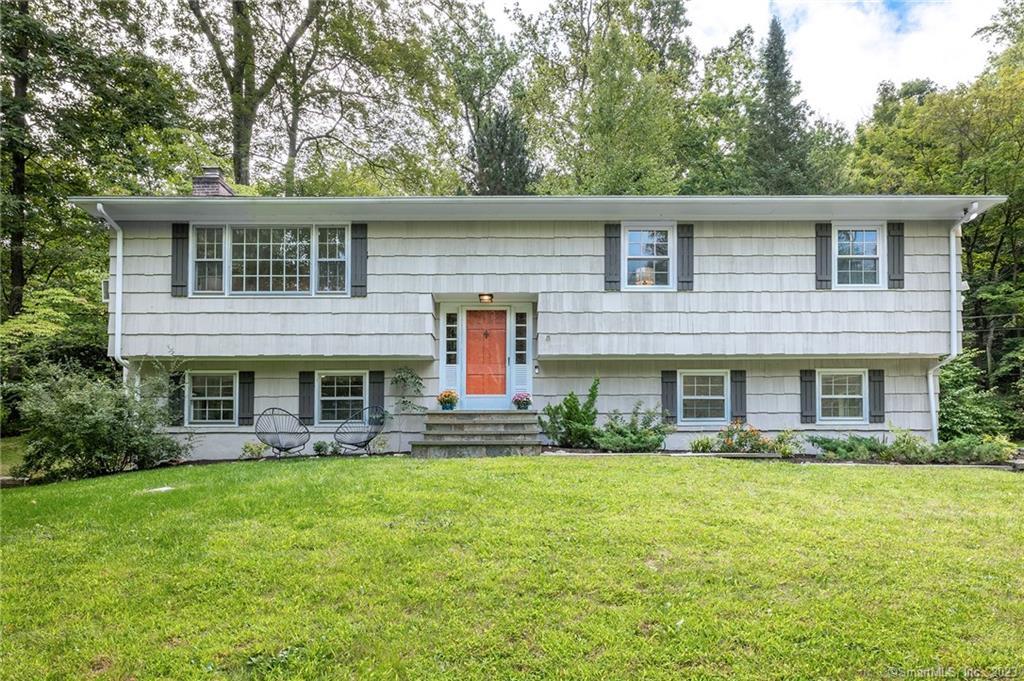 1 Hidden Lake Court Ridgefield, CT 06877 - Photo 1 of 1 a front view of a house with garden
