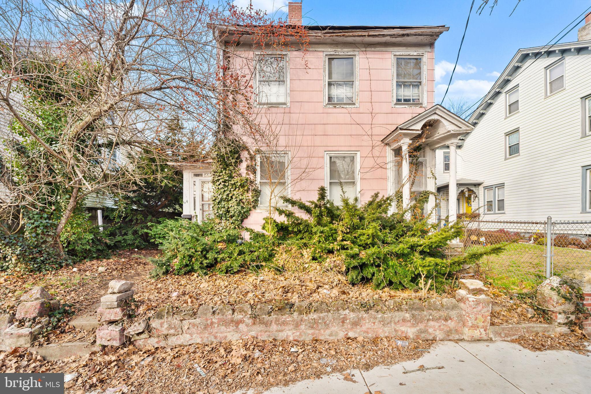 64 Walnut Street Bridgeton, NJ 08302 - Photo 1 of 26 a front view of a house with a garden