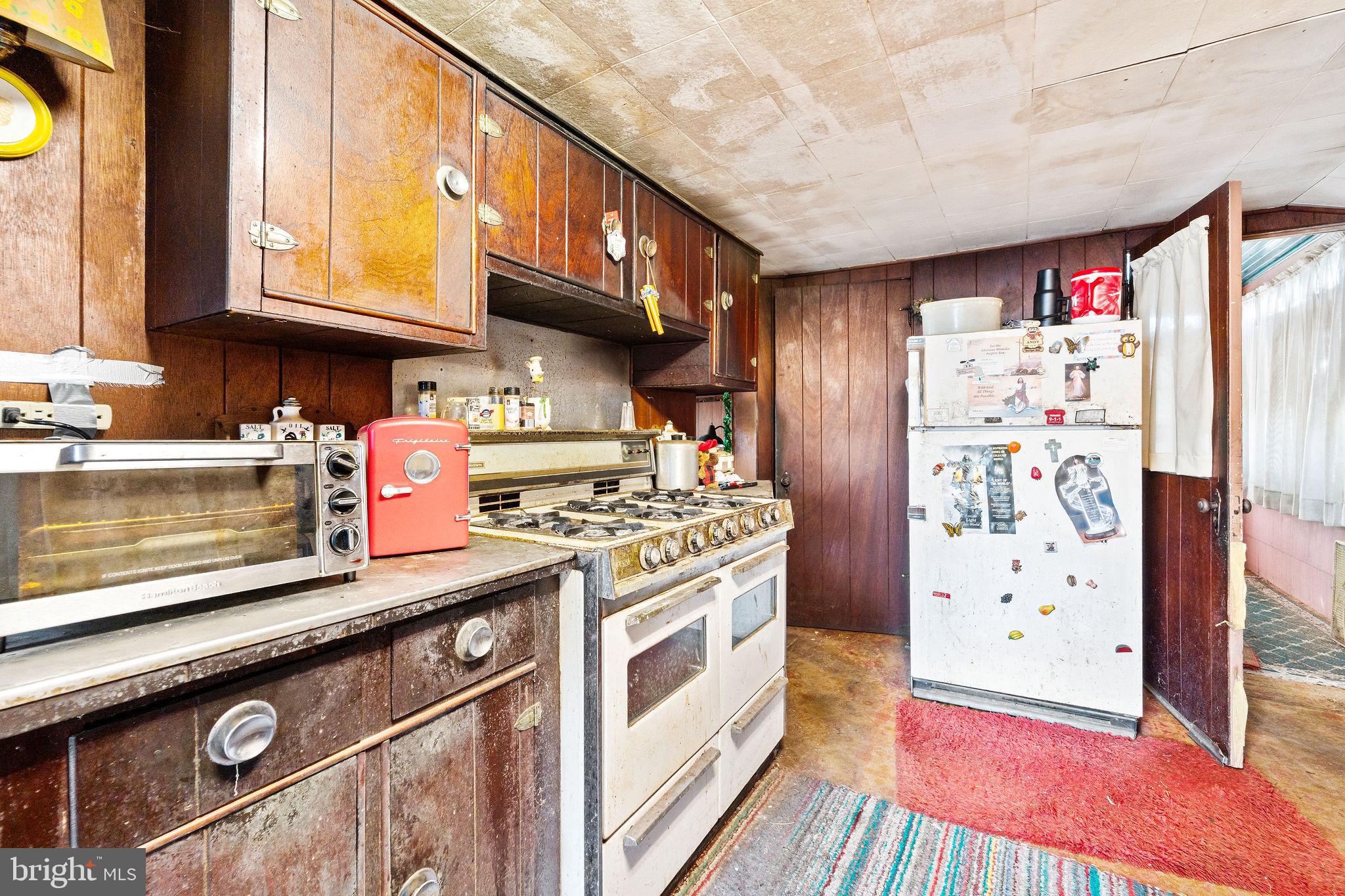 64 Walnut Street Bridgeton, NJ 08302 - Photo 16 of 26 a kitchen with stainless steel appliances granite countertop a refrigerator and a stove
