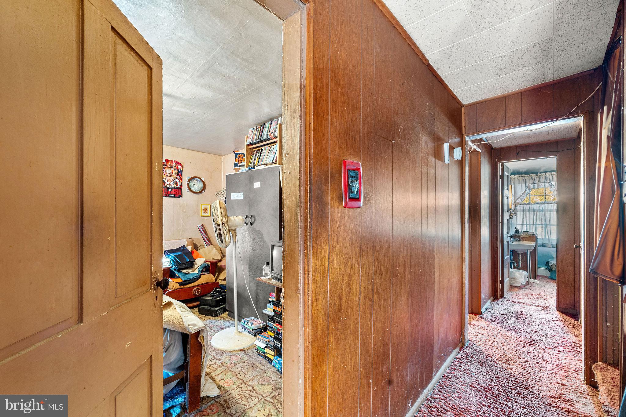 64 Walnut Street Bridgeton, NJ 08302 - Photo 17 of 26 a view of a hallway to a livingroom with furniture and windows