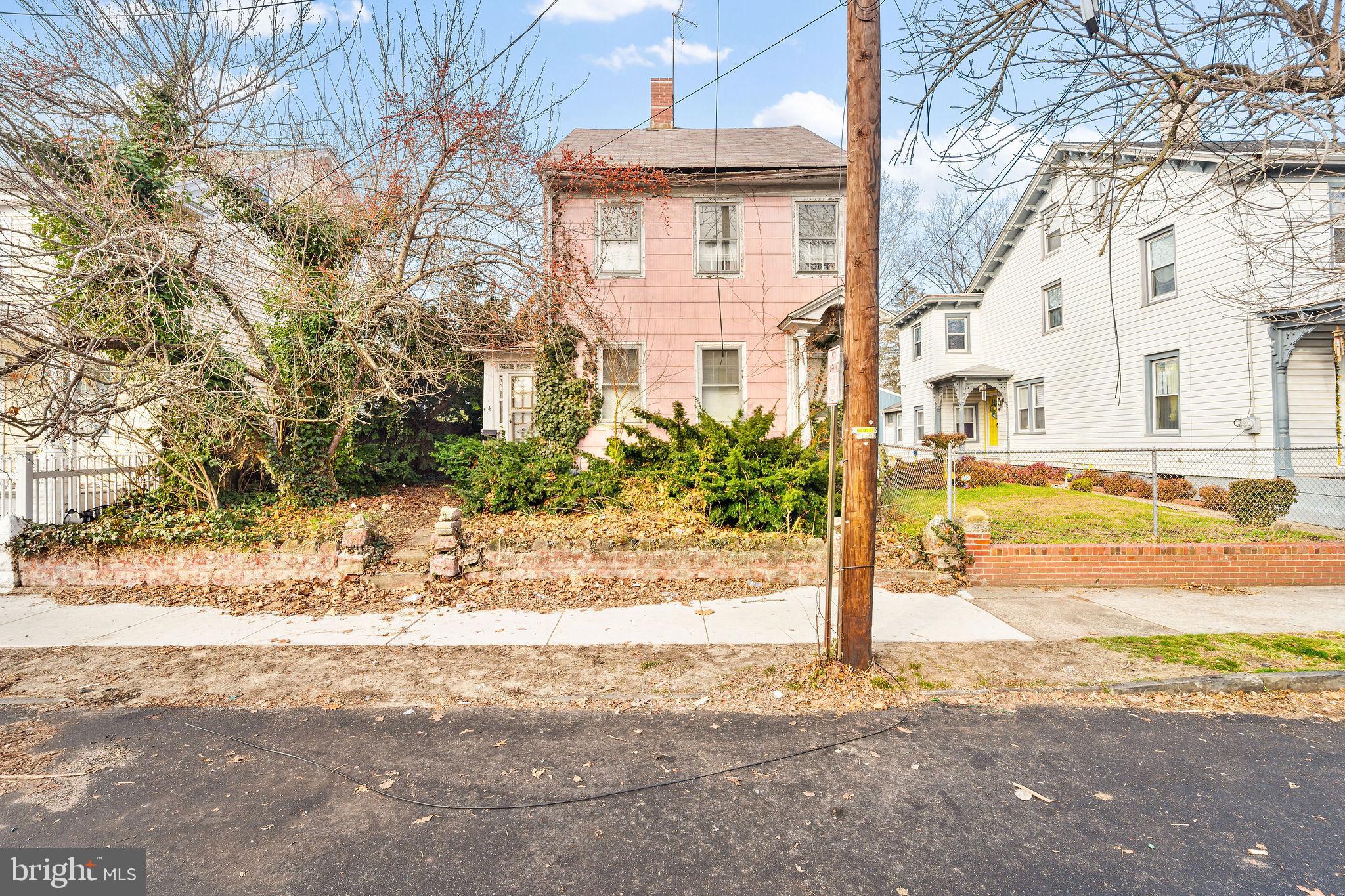 64 Walnut Street Bridgeton, NJ 08302 - Photo 2 of 26 a front view of a house with a yard