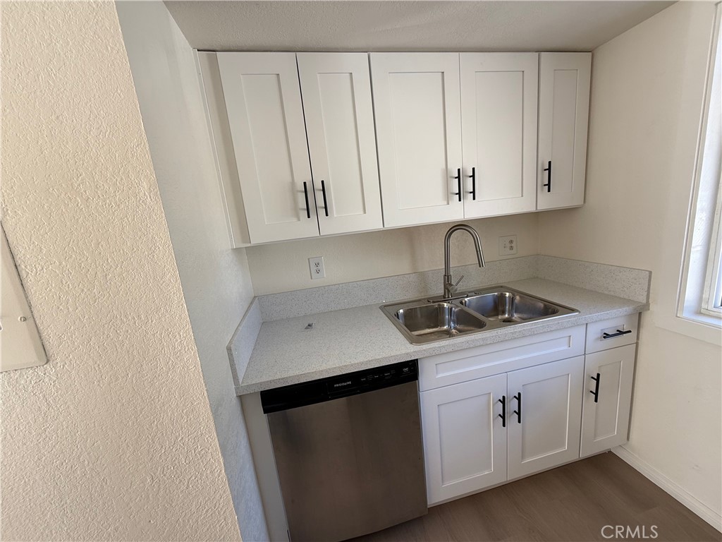 5010 Brooks Street, Unit 2 Riverside, CA 92506 - Photo 8 of 22 a kitchen with stainless steel appliances granite countertop white cabinets sink and dishwasher