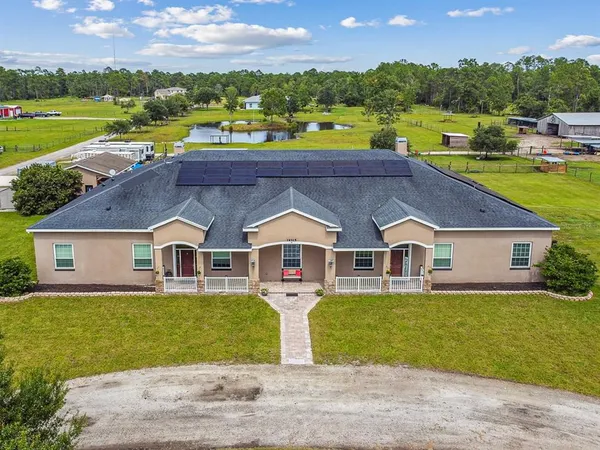 a aerial view of a house with a big yard