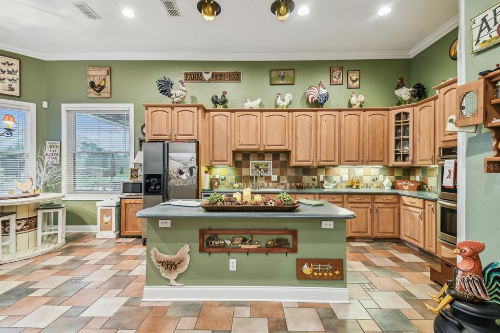 19315 Lake Pickett Road Orlando, FL 32820 - Photo 16 of 90 a kitchen with stainless steel appliances granite countertop a stove a sink and a refrigerator