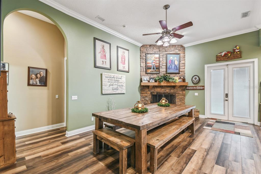 19315 Lake Pickett Road Orlando, FL 32820 - Photo 17 of 90 a view of a dining room with furniture window and wooden floor