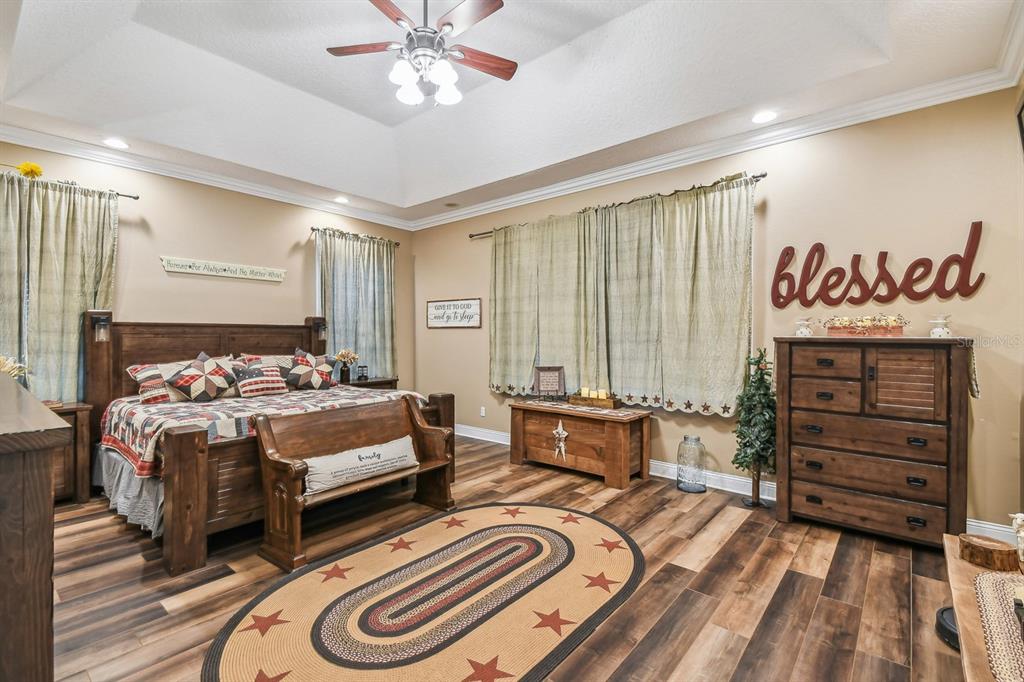 19315 Lake Pickett Road Orlando, FL 32820 - Photo 21 of 90 a bedroom with a bed and a chandelier