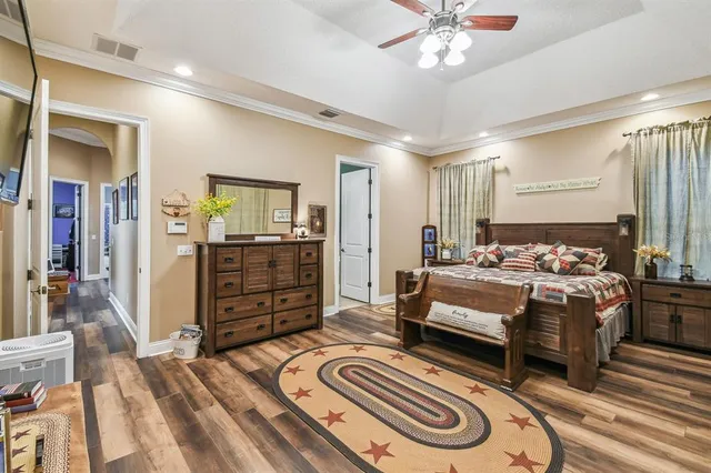 a large kitchen with kitchen island a stove a sink a dining table and chairs with wooden floor