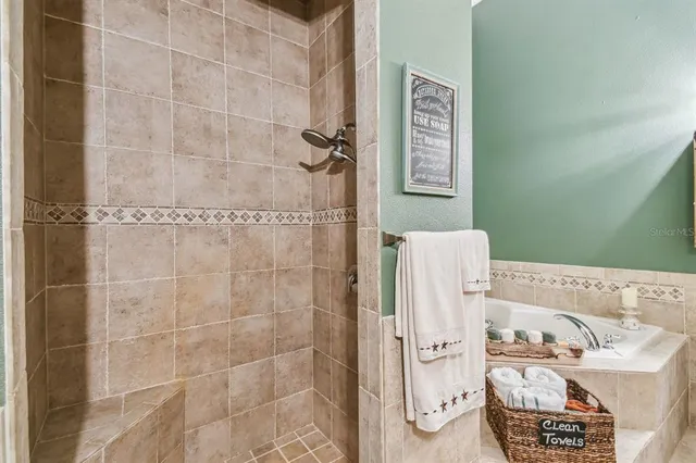 a bedroom with a bed a flat screen tv and dresser