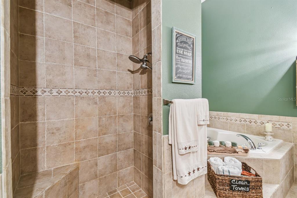 19315 Lake Pickett Road Orlando, FL 32820 - Photo 26 of 90 a bathroom with a bathtub and shower