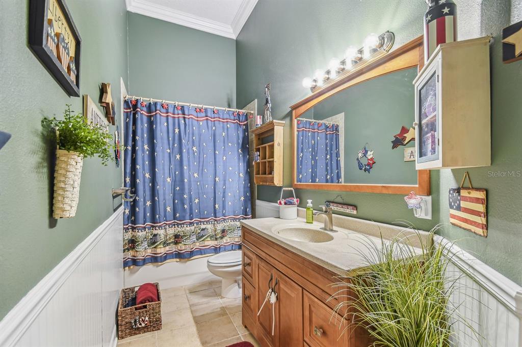 19315 Lake Pickett Road Orlando, FL 32820 - Photo 30 of 90 a bathroom with a sink a vanity and a mirror