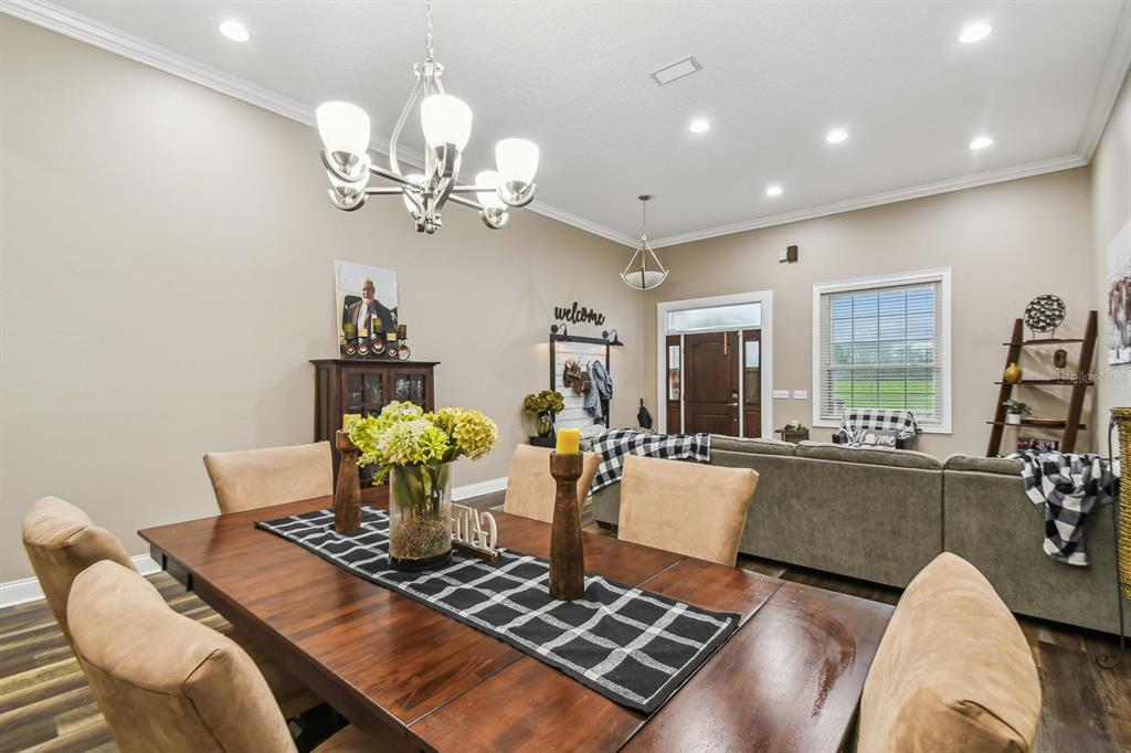 19315 Lake Pickett Road Orlando, FL 32820 - Photo 35 of 90 a living room with furniture a chandelier and a dining table