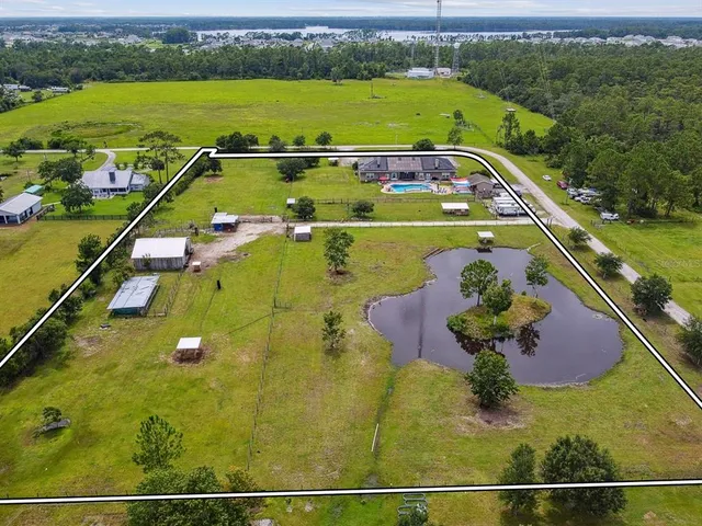 a view of a hallway with a dinning table and chairs