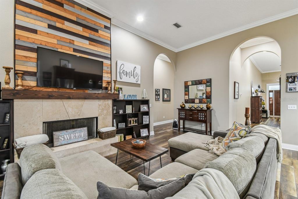 19315 Lake Pickett Road Orlando, FL 32820 - Photo 44 of 90 a living room with furniture a flat screen tv and a fireplace