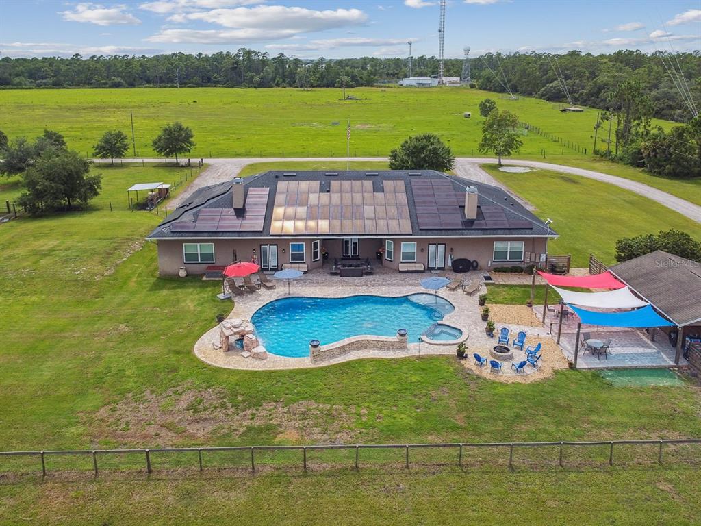 19315 Lake Pickett Road Orlando, FL 32820 - Photo 5 of 90 a aerial view of a house with a big yard
