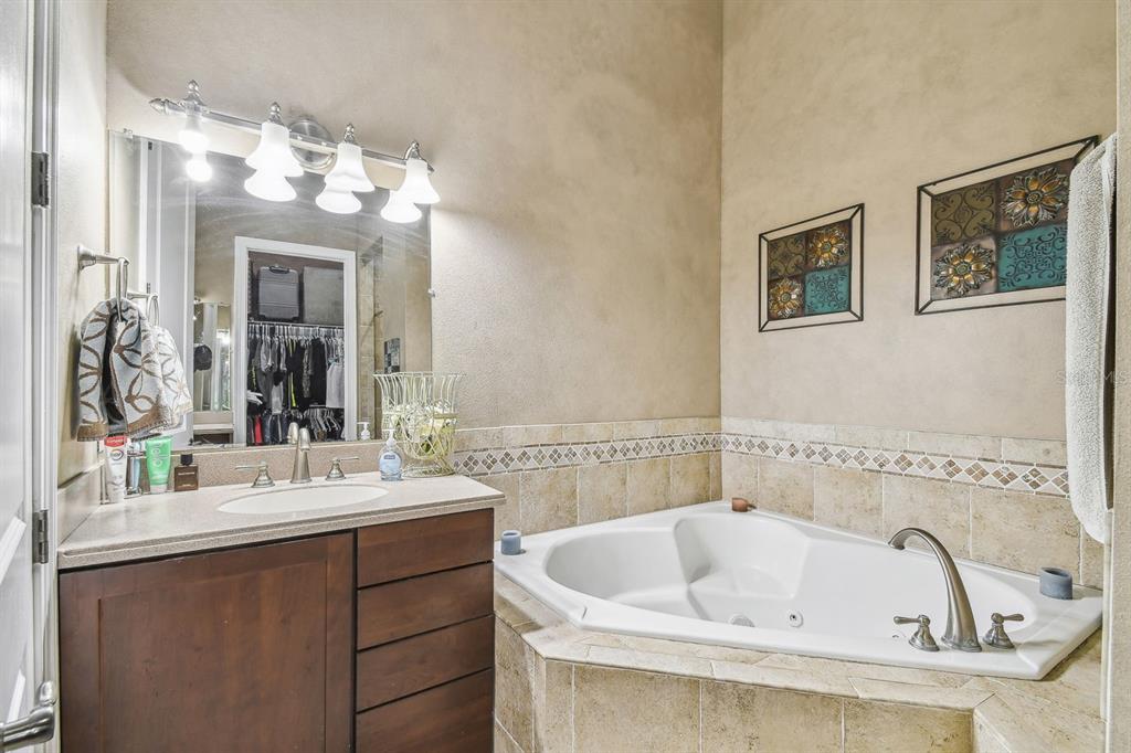 19315 Lake Pickett Road Orlando, FL 32820 - Photo 53 of 90 a bathroom with a sink and a mirror