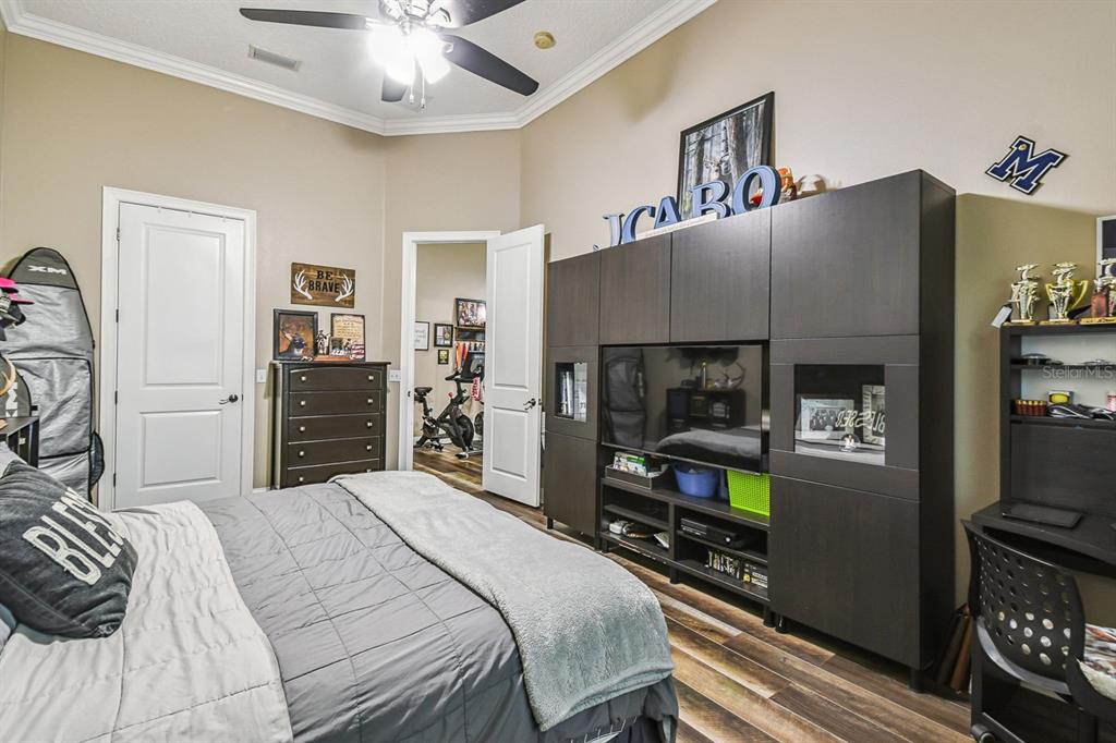 19315 Lake Pickett Road Orlando, FL 32820 - Photo 56 of 90 a bedroom with a bed and a television