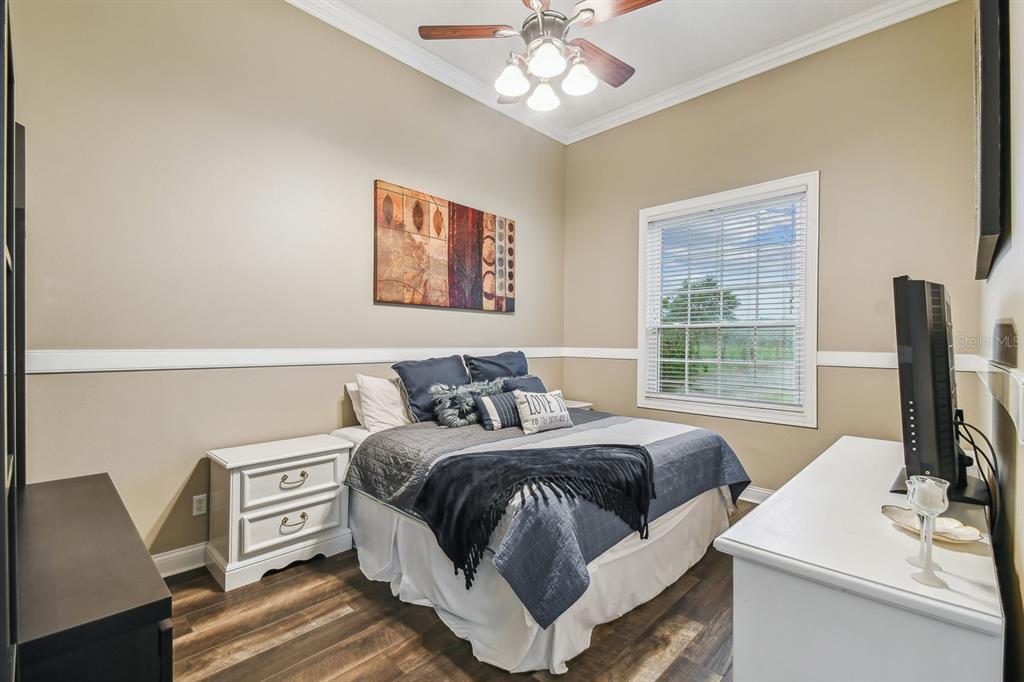 19315 Lake Pickett Road Orlando, FL 32820 - Photo 57 of 90 a bedroom with a bed and a flat screen tv