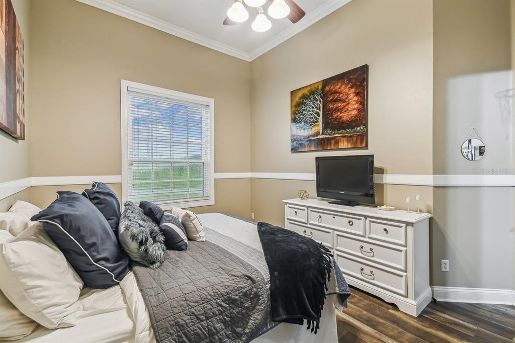 19315 Lake Pickett Road Orlando, FL 32820 - Photo 58 of 90 a bedroom with a bed and a television