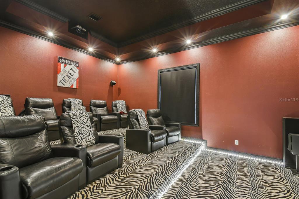 19315 Lake Pickett Road Orlando, FL 32820 - Photo 62 of 90 a media room with lots of chairs and a projector