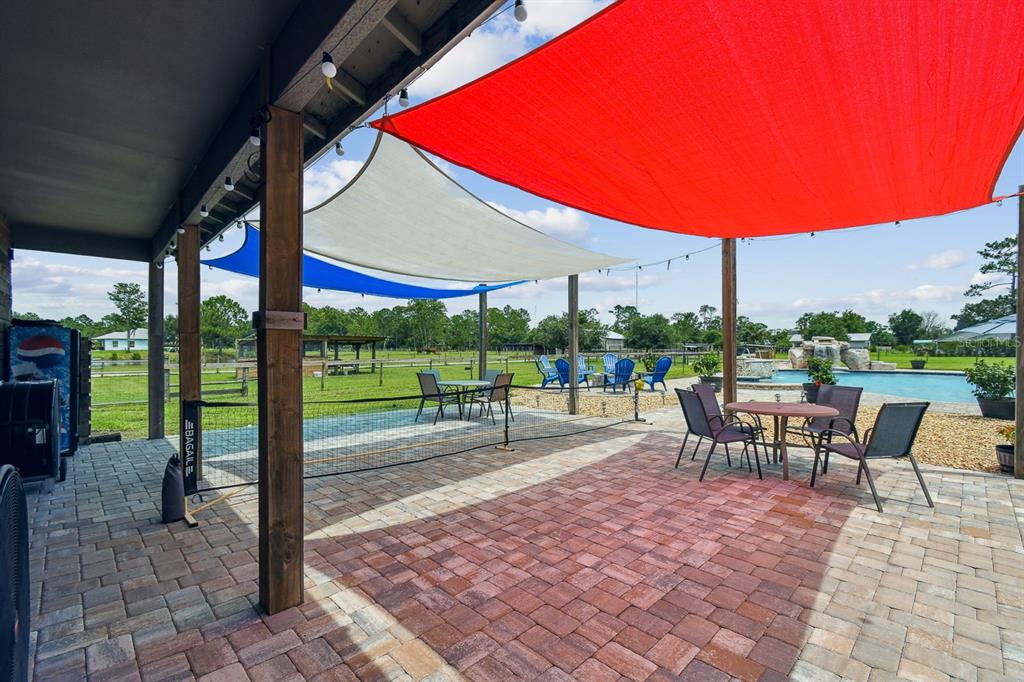 19315 Lake Pickett Road Orlando, FL 32820 - Photo 77 of 90 a view of a patio with a table chairs and a patio