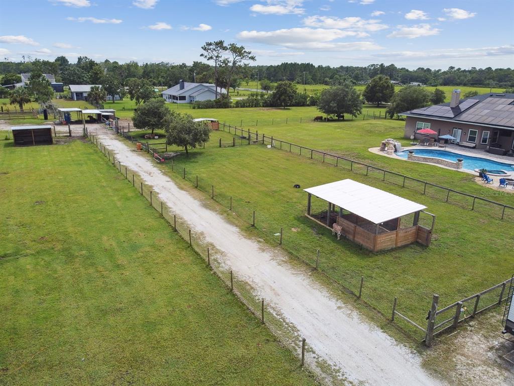 19315 Lake Pickett Road Orlando, FL 32820 - Photo 82 of 90 an aerial view of a house with a garden and lake view