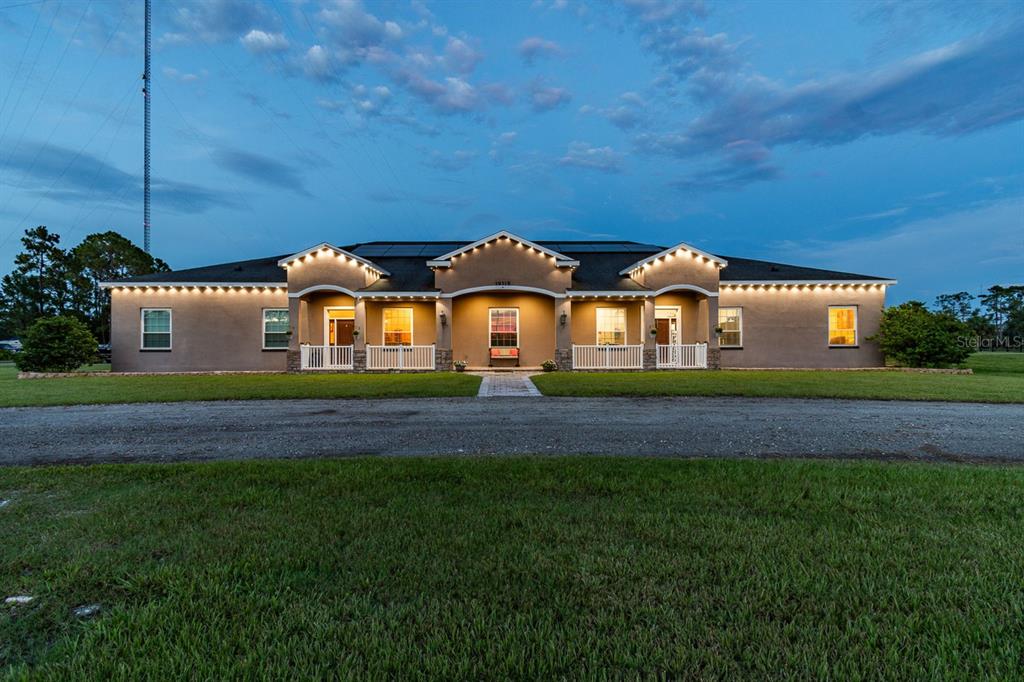 19315 Lake Pickett Road Orlando, FL 32820 - Photo 9 of 90 a front view of a house with a garden