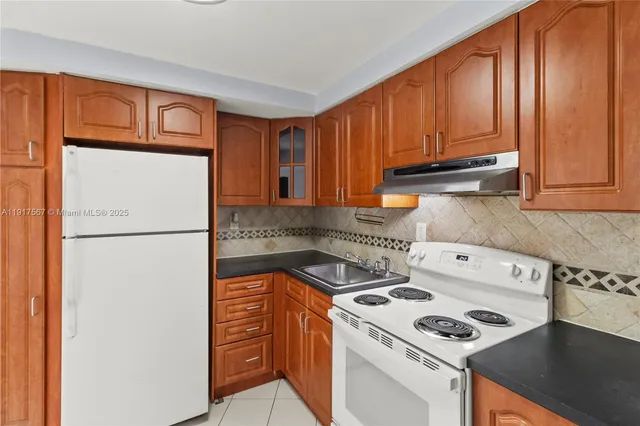 a kitchen with stainless steel appliances a refrigerator sink and cabinets