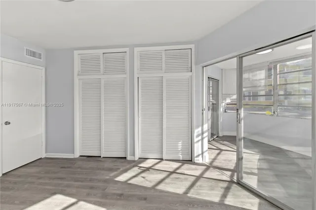 a view of an empty room with glass door