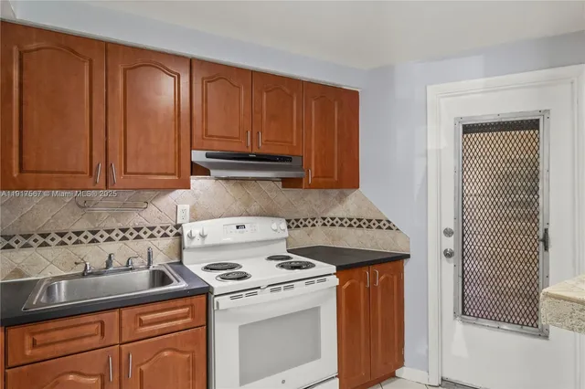 a kitchen with a stove and a microwave
