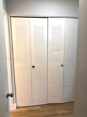 a bathroom with a toilet and a shower curtain