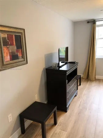 a bedroom with two beds and a chandelier