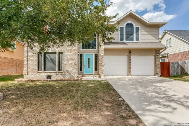 a view of white house with large windows and a small yard